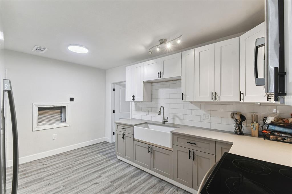 4706 Catherine Street New Port Richey, FL 34652 - Photo 16 of 45 a kitchen with a sink window and cabinets