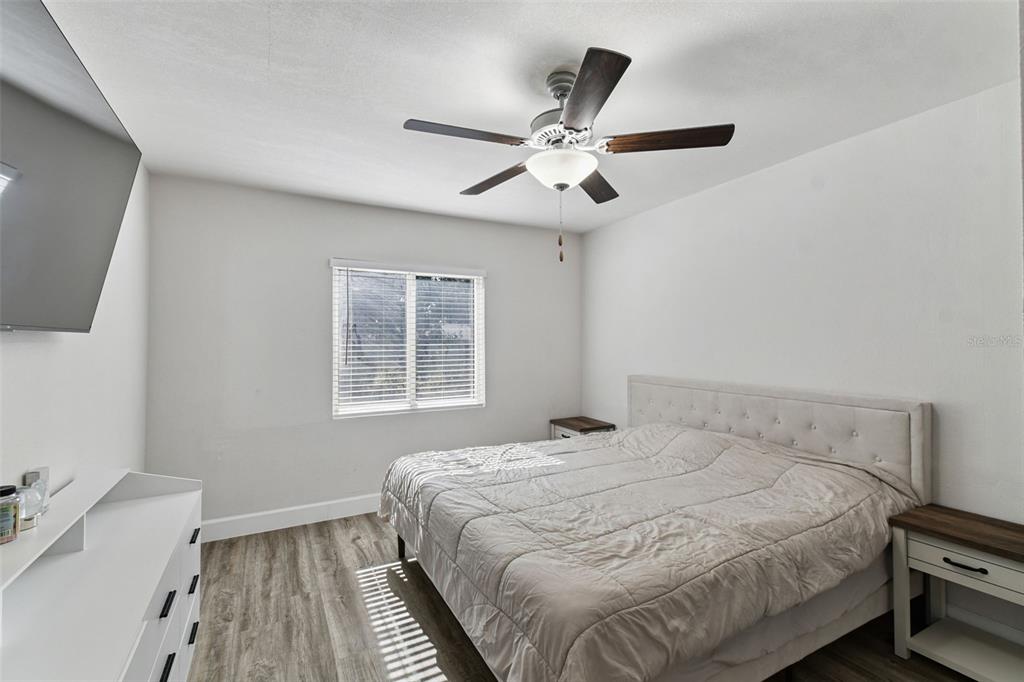 4706 Catherine Street New Port Richey, FL 34652 - Photo 20 of 45 a bedroom with a bed and a chandelier