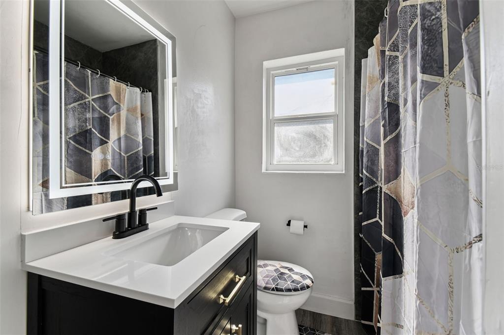 4706 Catherine Street New Port Richey, FL 34652 - Photo 22 of 45 a bathroom with a sink and a mirror