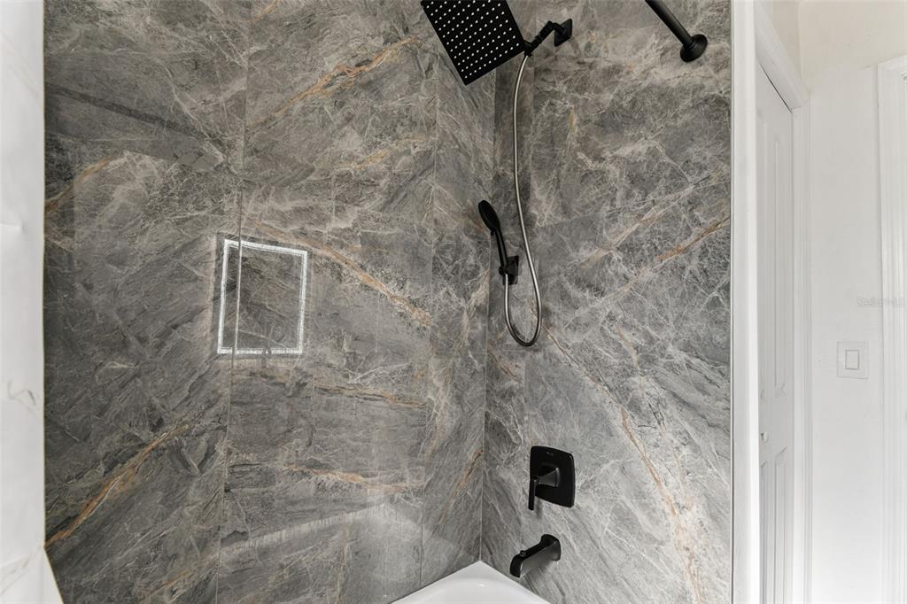 4706 Catherine Street New Port Richey, FL 34652 - Photo 23 of 45 a bathroom with a shower