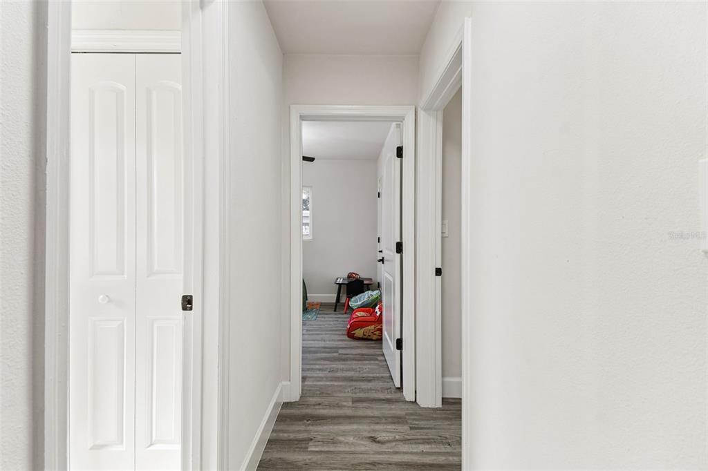 4706 Catherine Street New Port Richey, FL 34652 - Photo 25 of 45 a view of a hallway with wooden floor and closet