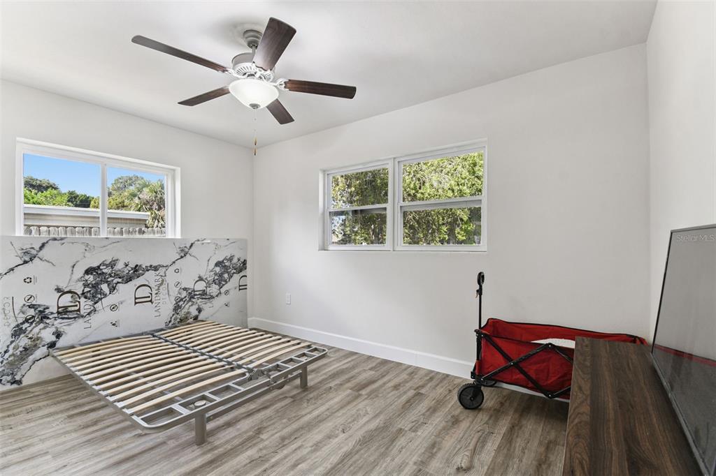 4706 Catherine Street New Port Richey, FL 34652 - Photo 26 of 45 a bedroom with a bed and wooden floor