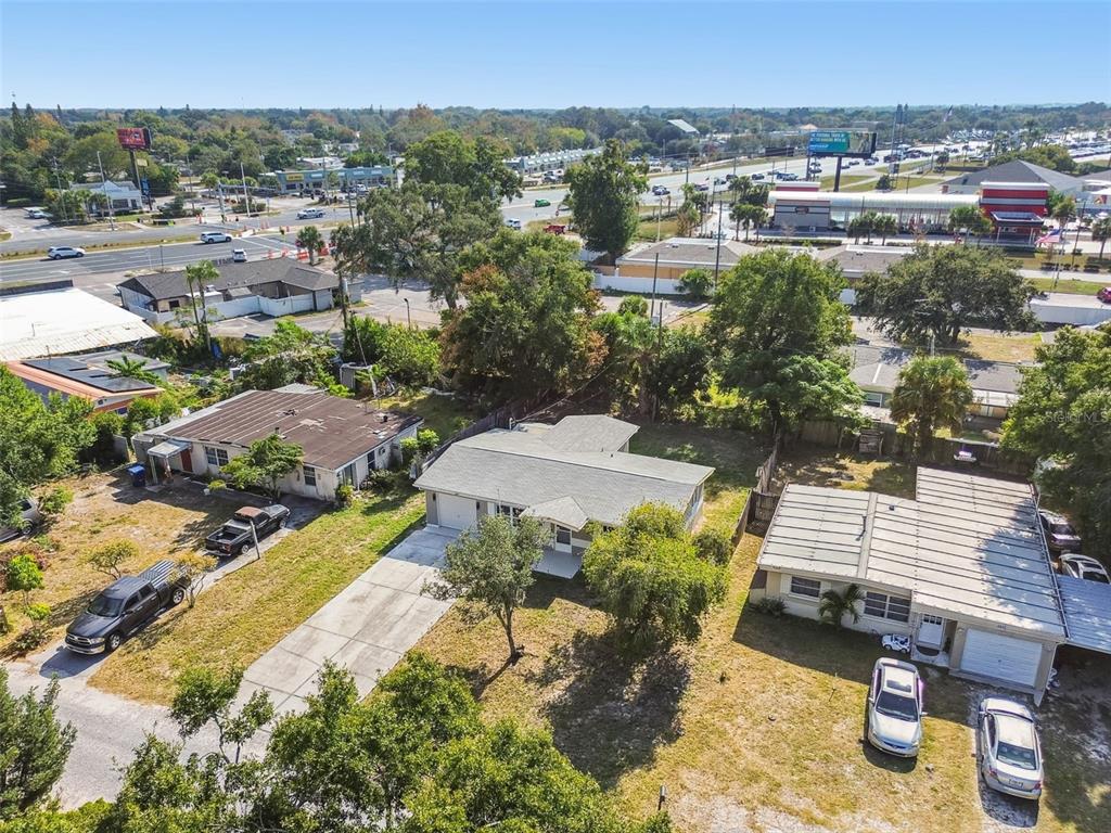 4706 Catherine Street New Port Richey, FL 34652 - Photo 36 of 45 an aerial view of a house with a yard and lake view