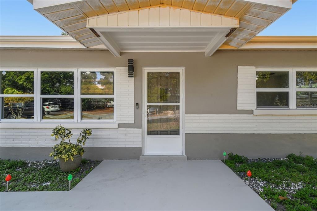 4706 Catherine Street New Port Richey, FL 34652 - Photo 7 of 45 a front view of a house with a garden