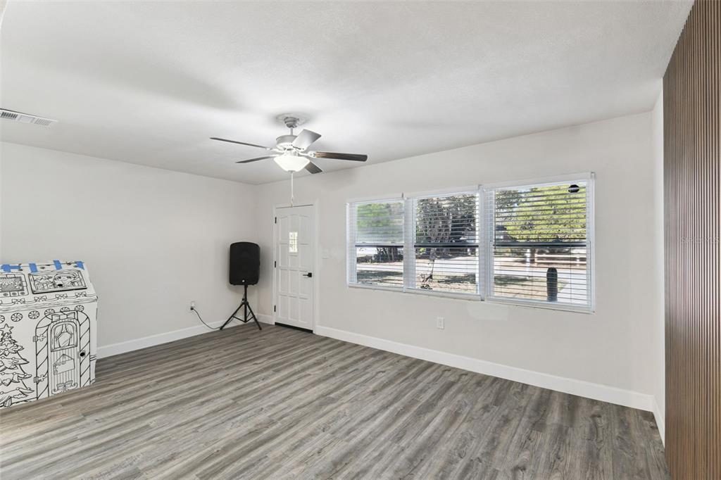4706 Catherine Street New Port Richey, FL 34652 - Photo 8 of 45 a view of a livingroom with a furniture wooden floor and chandelier