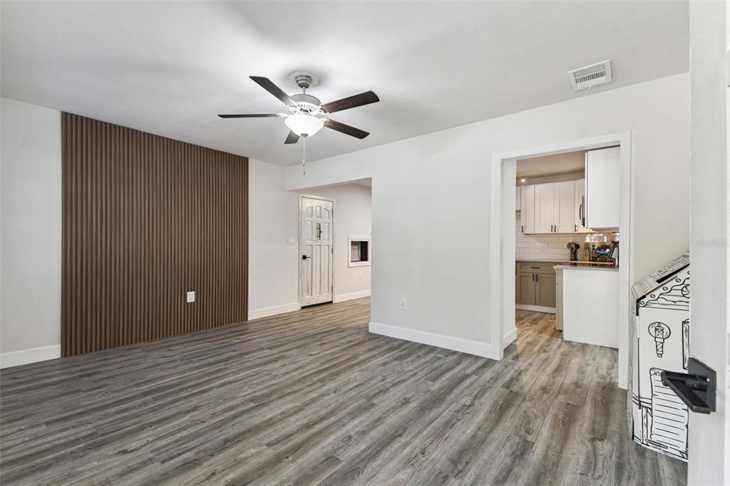 4706 Catherine Street New Port Richey, FL 34652 - Photo 9 of 45 a view of empty room with wooden floor and ceiling fan