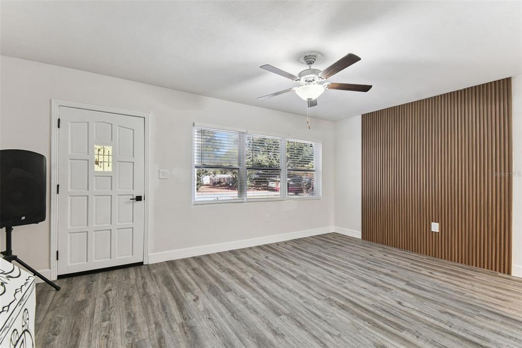 4706 Catherine Street New Port Richey, FL 34652 - Photo 10 of 45 a view of an empty room with a window and wooden floor