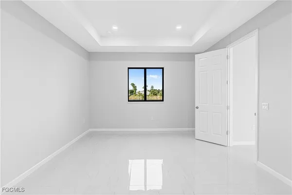 an empty room with windows and closet