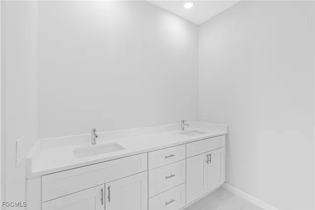 a bathroom with a sink and cabinets
