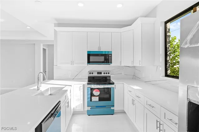 a kitchen with stainless steel appliances granite countertop a stove and a sink