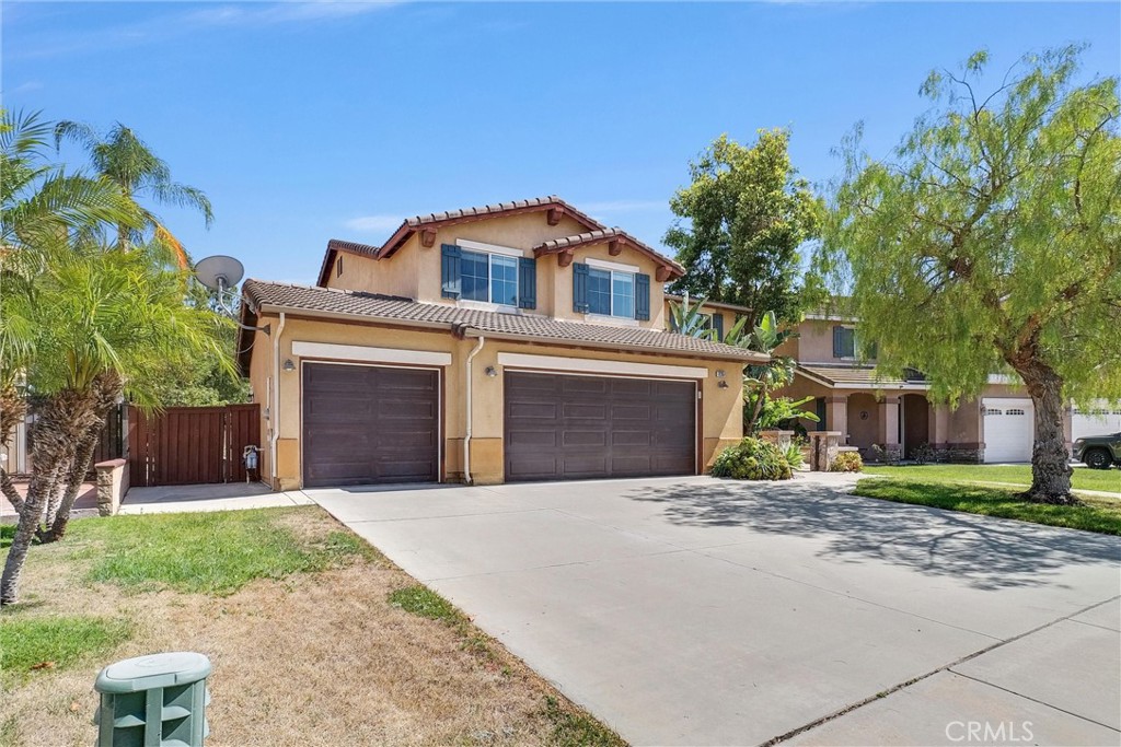 12351 Mesa Grove Drive Riverside, CA 92503 - Photo 1 of 25 a front view of a house with a yard and garage
