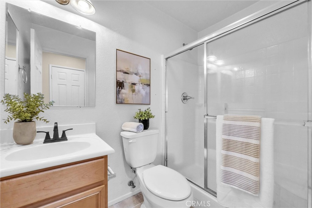 12351 Mesa Grove Drive Riverside, CA 92503 - Photo 11 of 25 a bathroom with a toilet a sink and shower