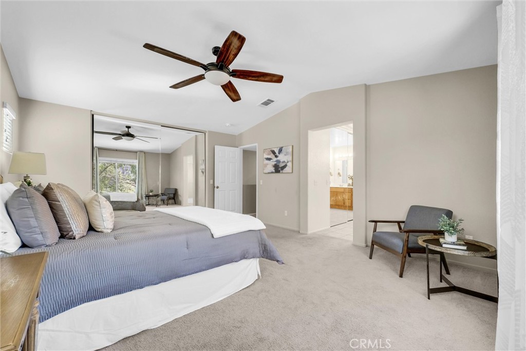 12351 Mesa Grove Drive Riverside, CA 92503 - Photo 16 of 25 a bedroom with a bed and a chandelier