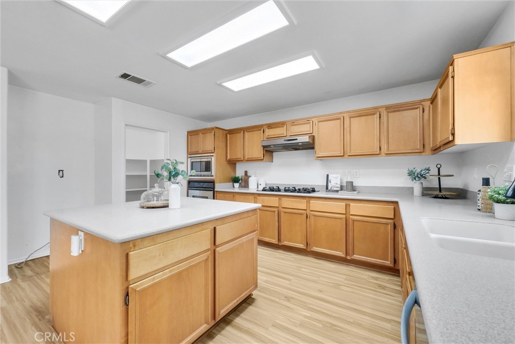 12351 Mesa Grove Drive Riverside, CA 92503 - Photo 8 of 25 a kitchen with granite countertop cabinets stainless steel appliances a sink and a counter top space
