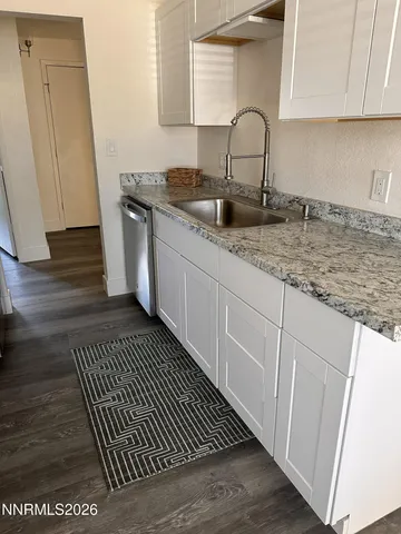 a kitchen with sink and cabinets