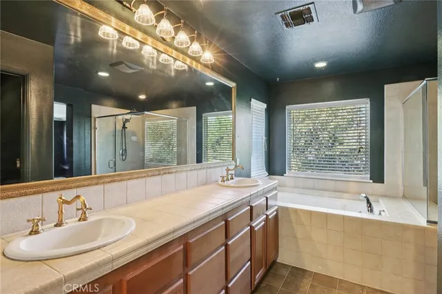 a large spacious bathroom with a large tub and sink
