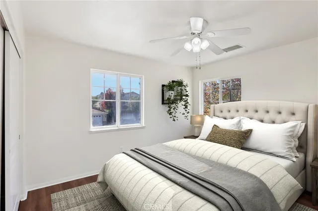 a bedroom with a large bed and a chandelier