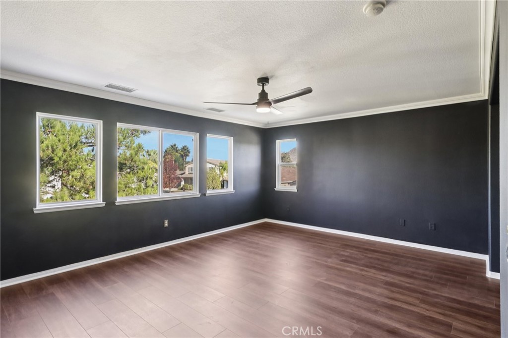 29144 Lighthouse Court Menifee, CA 92585 - Photo 16 of 35 a view of an empty room with wooden floor and a window