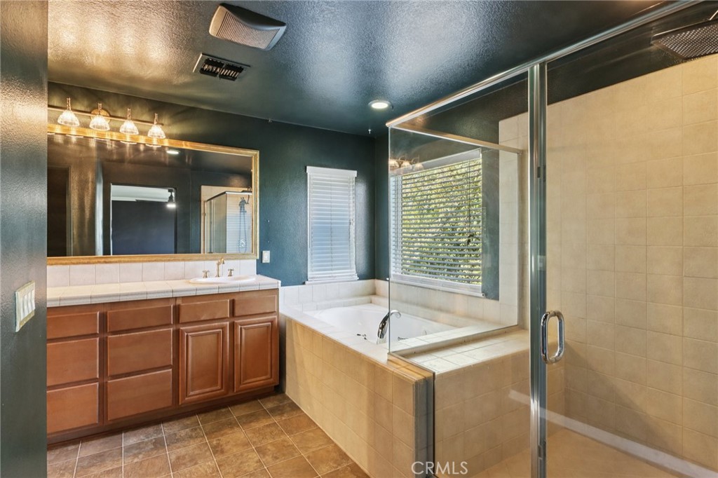 29144 Lighthouse Court Menifee, CA 92585 - Photo 17 of 35 a bathroom with a tub sink and mirror