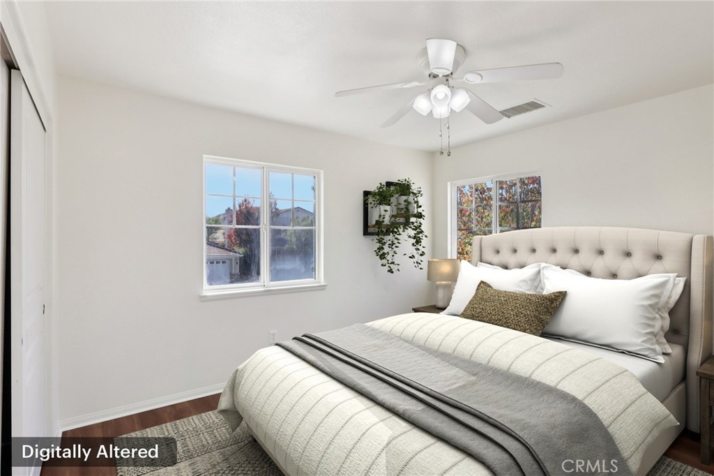 29144 Lighthouse Court Menifee, CA 92585 - Photo 19 of 35 a bedroom with a large bed and a chandelier