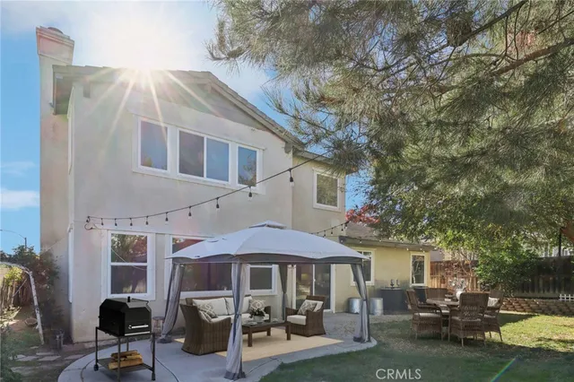 a patio with a table and chairs under an umbrella