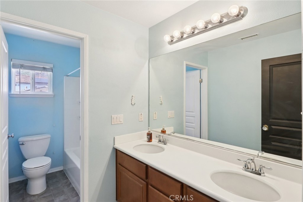 29144 Lighthouse Court Menifee, CA 92585 - Photo 22 of 35 a bathroom with a toilet a sink and mirror