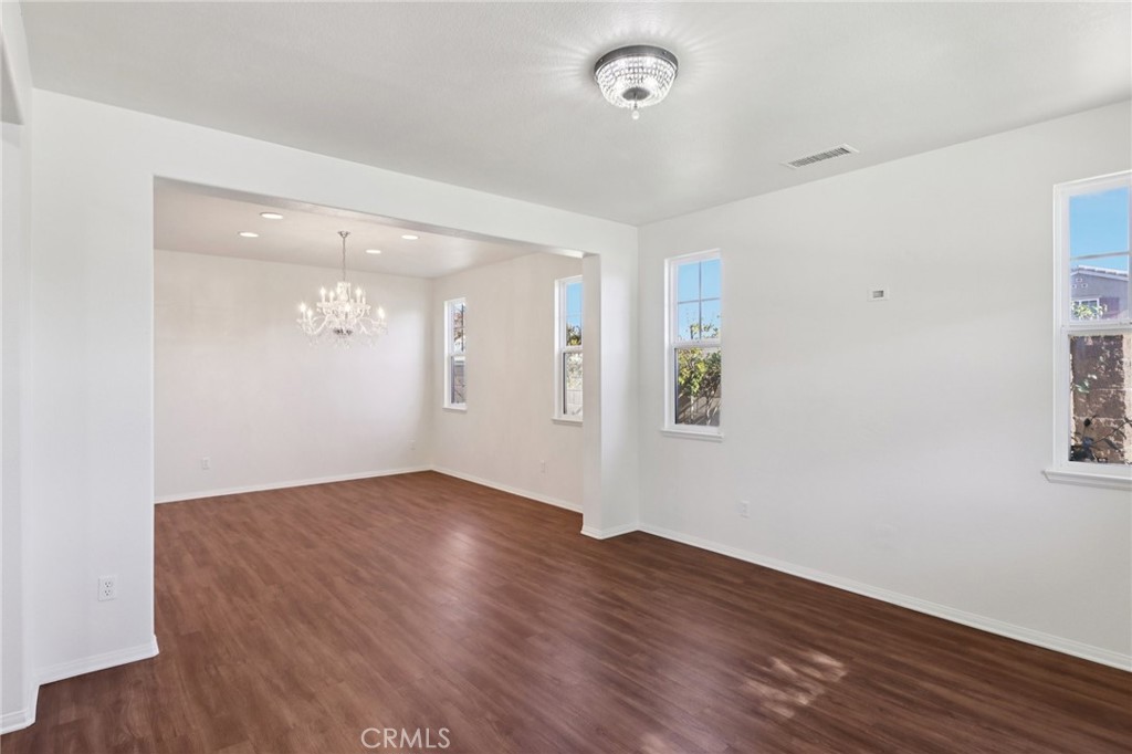 29144 Lighthouse Court Menifee, CA 92585 - Photo 4 of 35 an empty room with wooden floor and windows