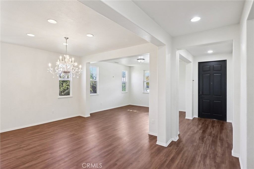 29144 Lighthouse Court Menifee, CA 92585 - Photo 5 of 35 a view of an empty room with wooden floor and a window