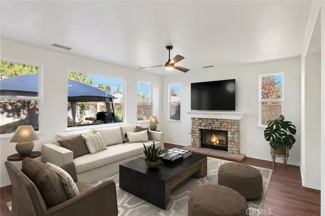 a living room with furniture fireplace and flat screen tv