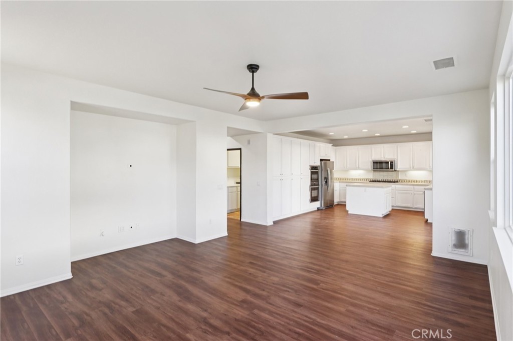 29144 Lighthouse Court Menifee, CA 92585 - Photo 9 of 35 a view of a kitchen with a sink dishwasher a refrigerator with wooden floor and a kitchen view