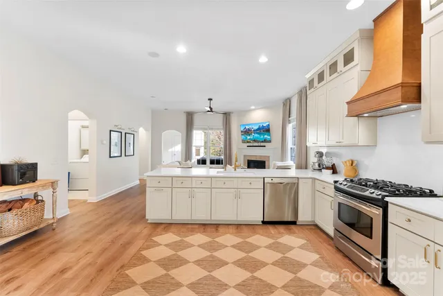 a kitchen with granite countertop a sink stove and cabinets