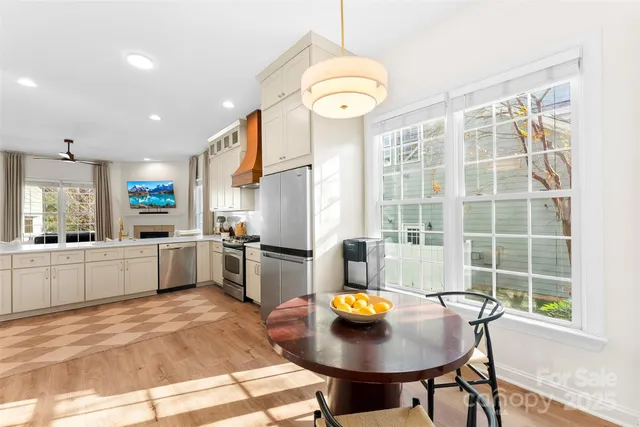 a kitchen with a sink a kitchen island a stove and a refrigerator with wooden floor
