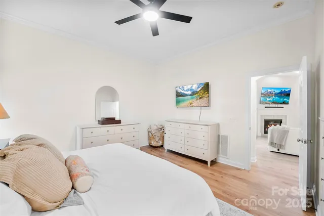 a bedroom with a bed and ceiling fan