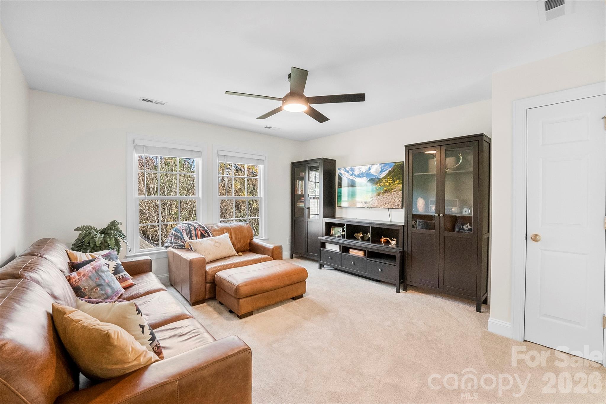 4115 Birkshire Heights Fort Mill, SC 29708 - Photo 28 of 36 a bedroom with furniture a large bed and a chandelier