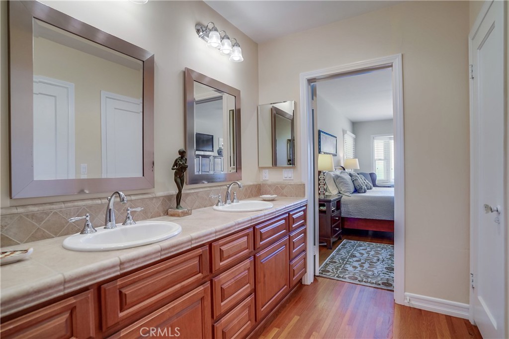 4010 Bluff Place San Pedro, CA 90731 - Photo 54 of 72 a en suite bathroom with a granite countertop double vanity sink and a mirror