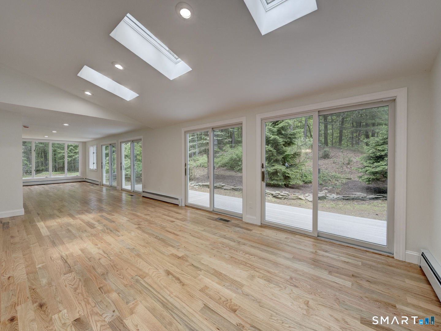 243 Brickyard Road Farmington, CT 06032 - Photo 10 of 34 Dining Room & Family Room ae flooded with light from 4 Sliders and skylights.