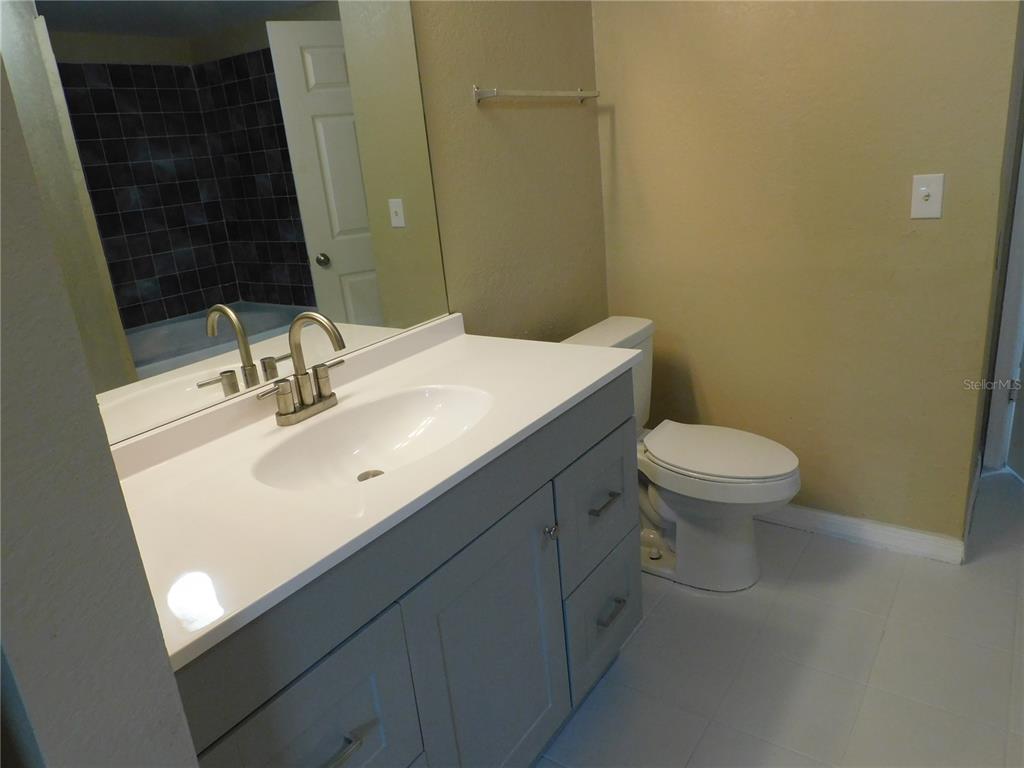 3480 Soho Street, Unit 101 Orlando, FL 32835 - Photo 15 of 29 a bathroom with a sink toilet and mirror
