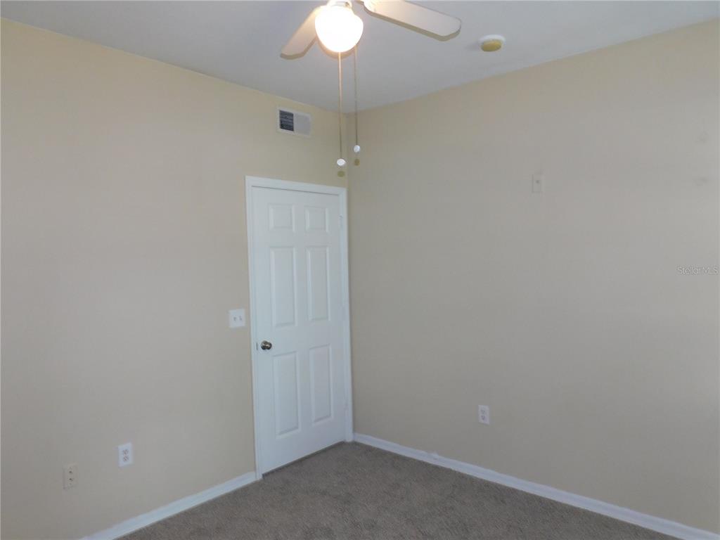 3480 Soho Street, Unit 101 Orlando, FL 32835 - Photo 20 of 29 an empty room with a chandelier fan