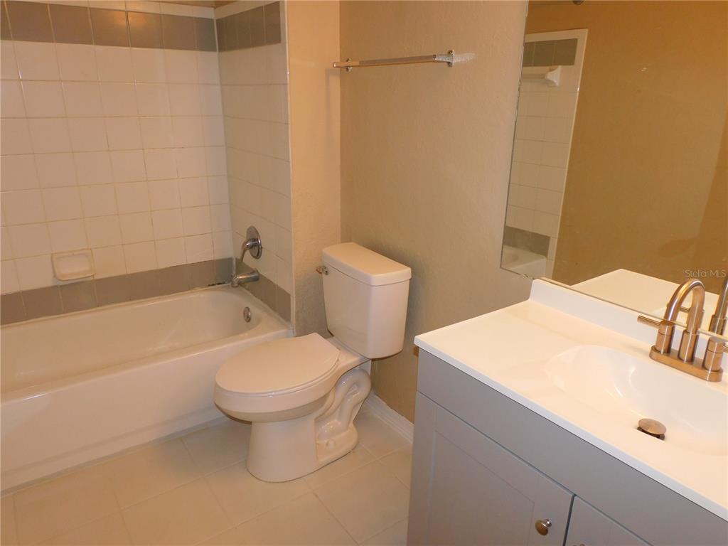 3480 Soho Street, Unit 101 Orlando, FL 32835 - Photo 24 of 29 a bathroom with a sink a toilet and shower