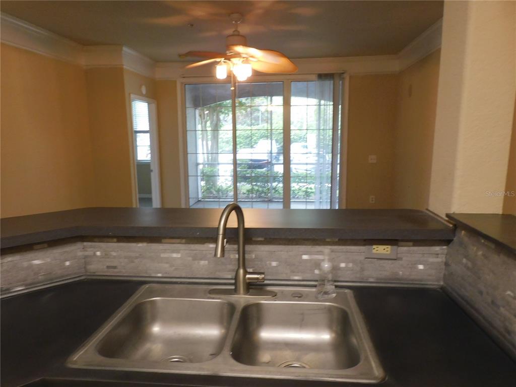 3480 Soho Street, Unit 101 Orlando, FL 32835 - Photo 9 of 29 a kitchen with a sink and a window