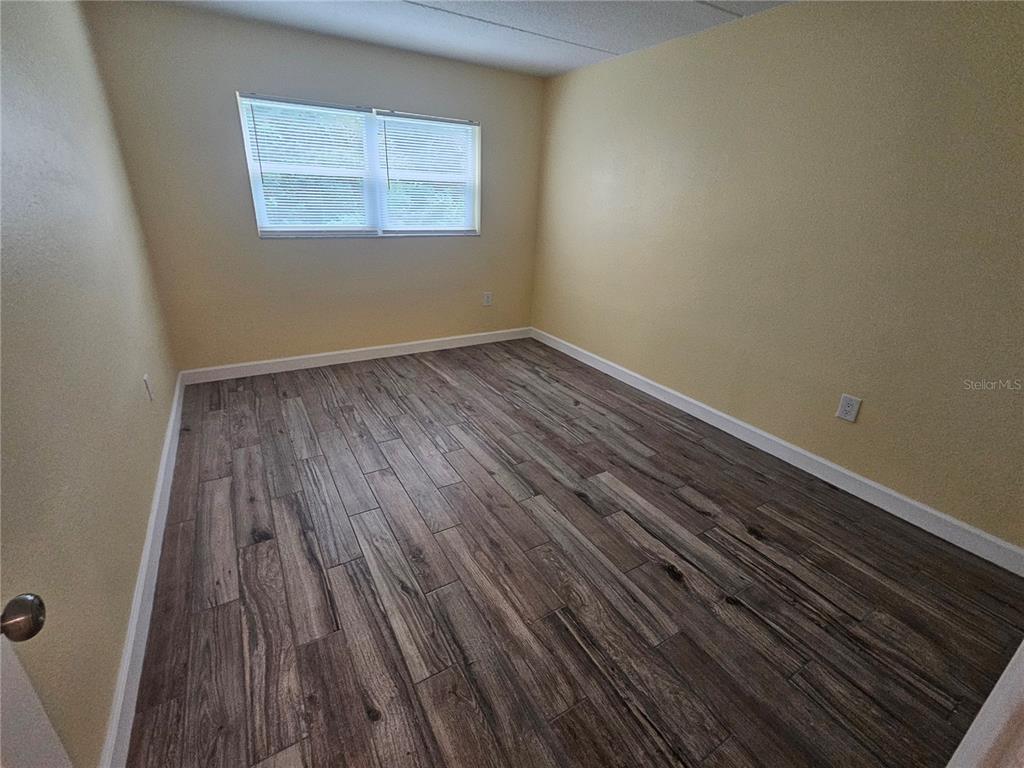 2045 Alpine Road, Unit 3 Clearwater, FL 33755 - Photo 14 of 18 a view of a room with wooden floor and a window