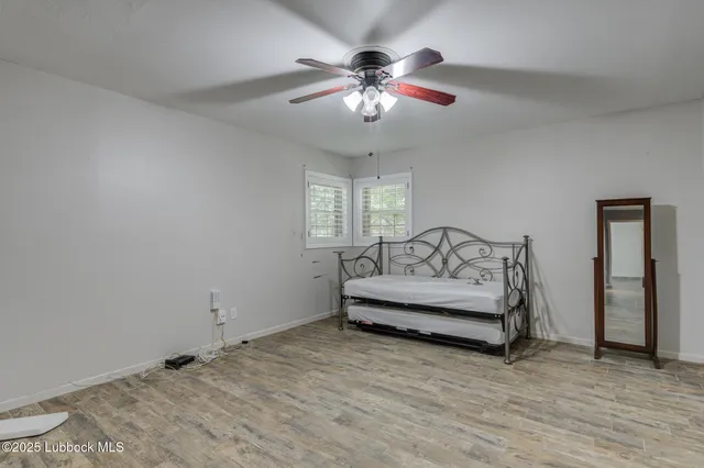 a view of a kitchen with wooden floor and windows