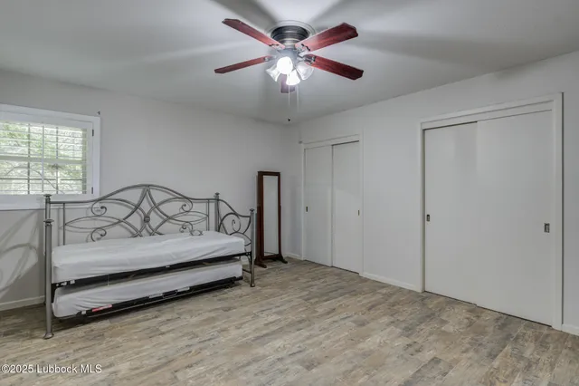 a view of a hallway with wooden shelves