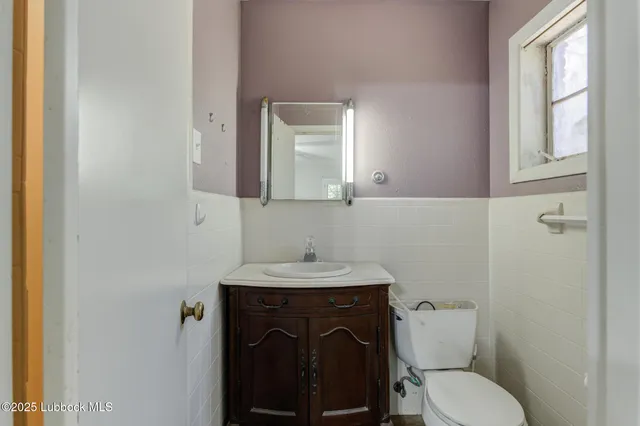 a view of a hallway with wooden shelves