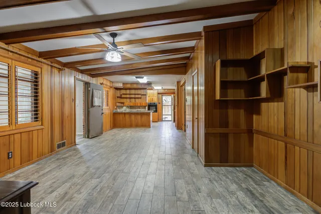 a view of a kitchen with wooden floor and a window