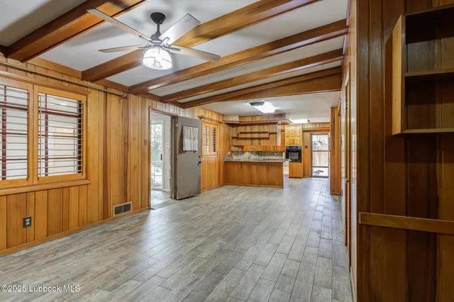 a view of a bathroom with wooden floor and a glass door