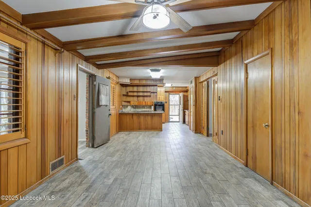 a kitchen with stainless steel appliances granite countertop a stove and a wooden floors