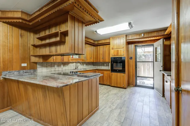 a view of empty room with wooden floor and floor to ceiling window