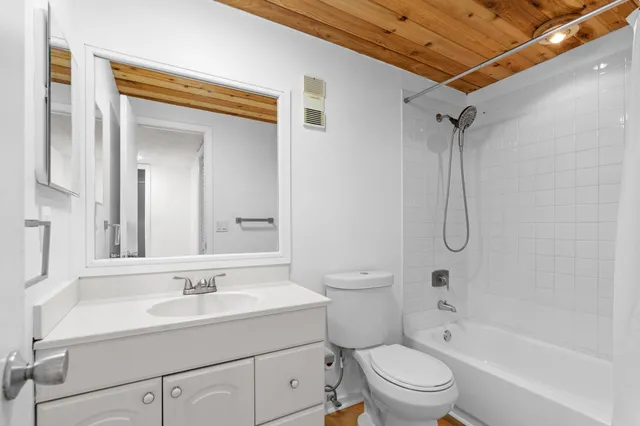 a bathroom with a sink toilet vanity and shower