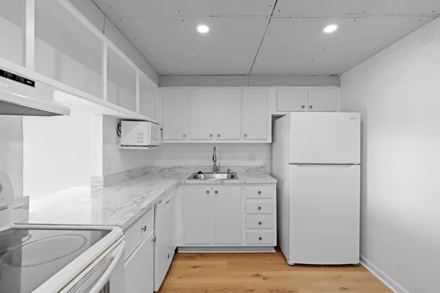 a kitchen with cabinets appliances and a counter space